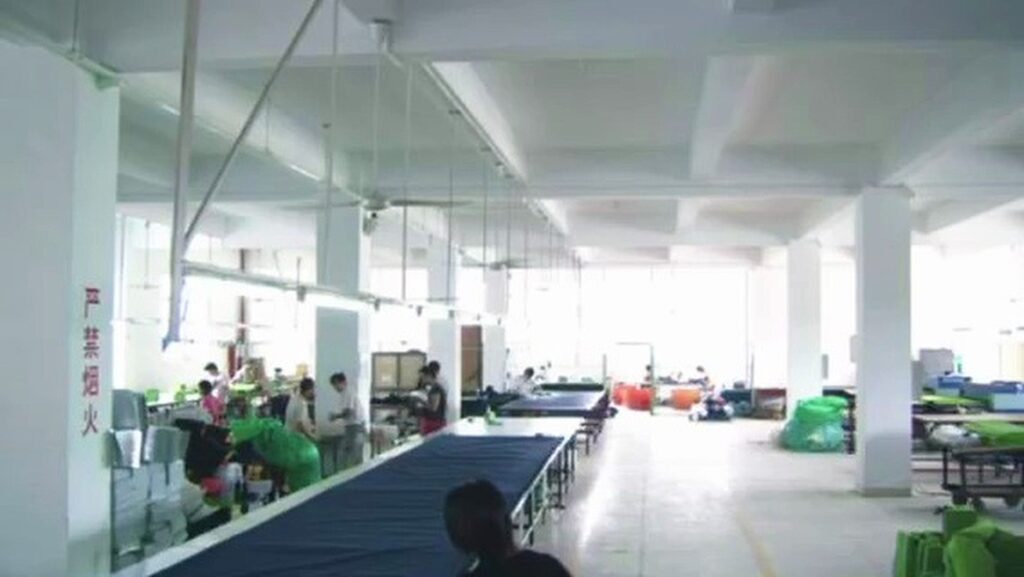 Top Sound (Xiamen) bag factory sewing workshop interior with assembly lines and skilled workers producing OEM/ODM cooler bags, pet carriers, and insulated thermal bags