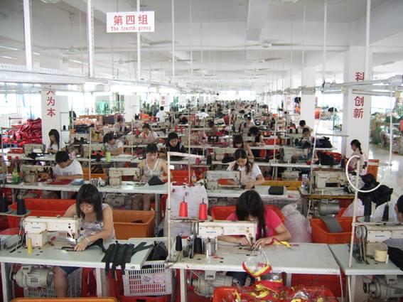 Organized bag sewing assembly line with workers producing fabric components in Quanzhou factory