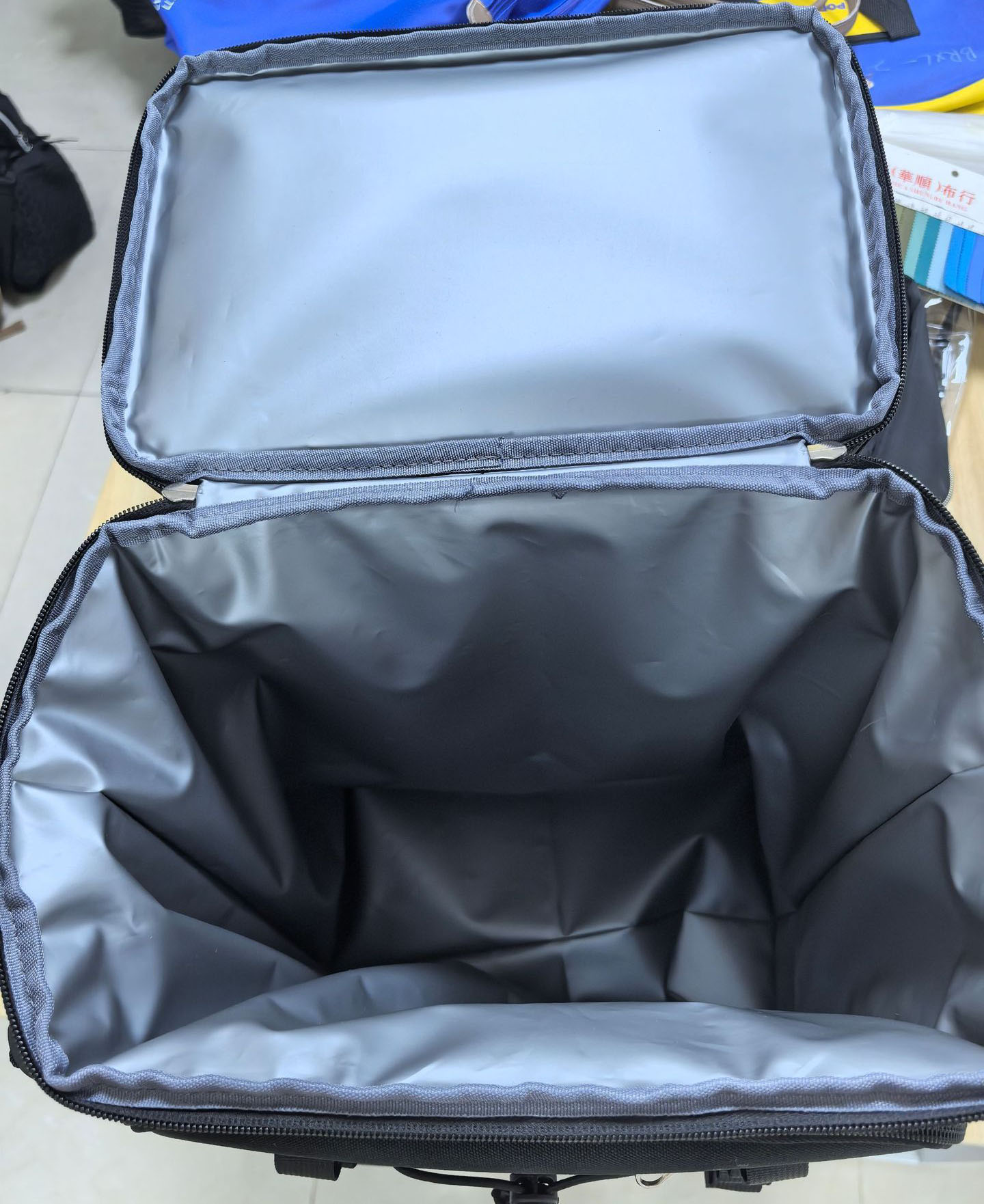 Close-up view of front zippered utility pocket designed for storing napkins, keys, and picnic cutlery